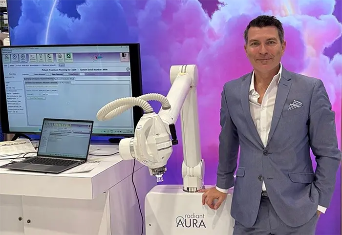 Hugo, founder of SkinRadX, showing off the treatment machine at a medical expo